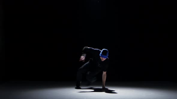 Dancer Man in Hat Starts Dancing Breakdance on Black alt