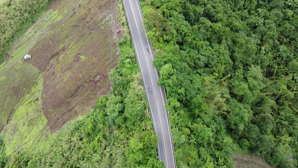 Aerial view of a motorcycle running along the mountain road by drone