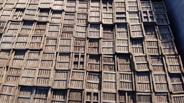 Warehouses. Stacks of Wooden Crates for Fruit, Large Boxes for Apples Stand Outdoors, on Warehouse alt