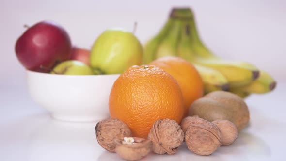 Girl Lays Fruits and Nuts on the Table With Slow Motion, Stock Footage