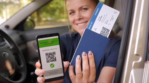 Young Woman Shows Smartphone with QRcode in Car alt