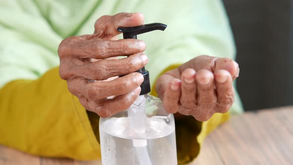 Close Up of Senior Women Hand Using Sanitizer Gel for Preventing Virus alt