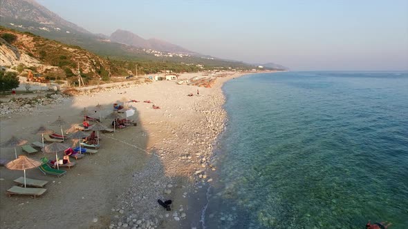 People on shore of beach in Albania alt