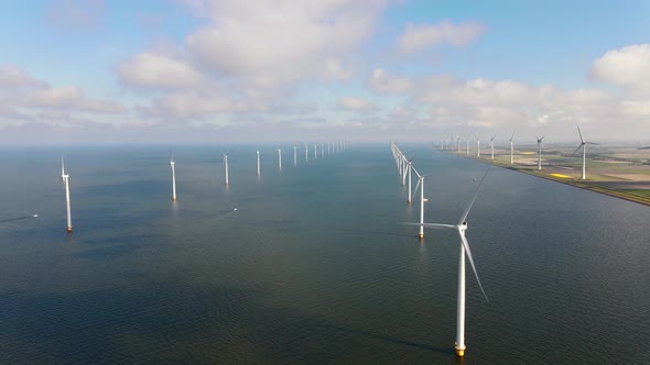 Offshore Windmill Park with Clouds and a Blue Sky Windmill Park in the Ocean Drone Aerial View with alt