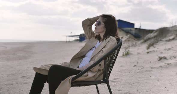 Portrait of Woman relaxes on the seaside at the sandy ocean beach. Mental Healthcare. alt