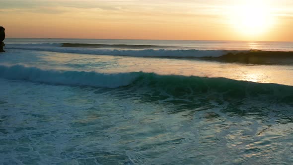 Moving over large waves at sunset