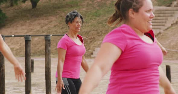 Female friends enjoying exercising at boot camp together alt