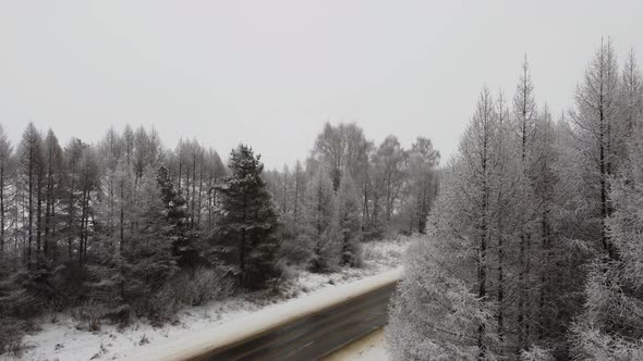 Drone Fly Up Above Winter Forest and Highway