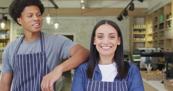 Animation of happy diverse female and male waiters at coffee shop alt