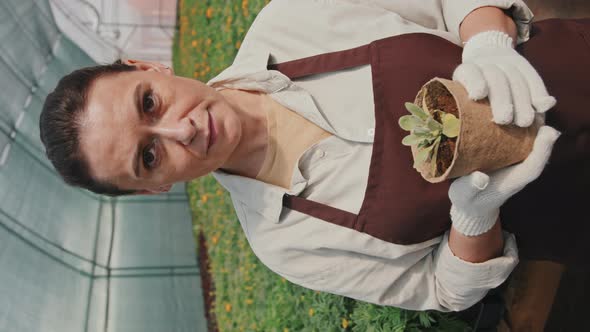 Portrait of Woman with Potted Plant alt