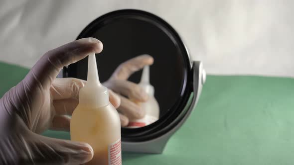 A Bottle of Hair Dye Chemicals Being Mixed