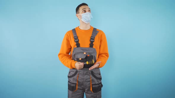 Thoughtful Male Worker Medium Shot Isolated on Blue Studio Background alt