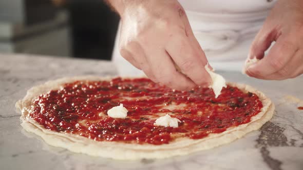 Italian Chef Making Margaritta Pizza with Tomato Sause and Mozzarella Traditional Food in Italy High alt