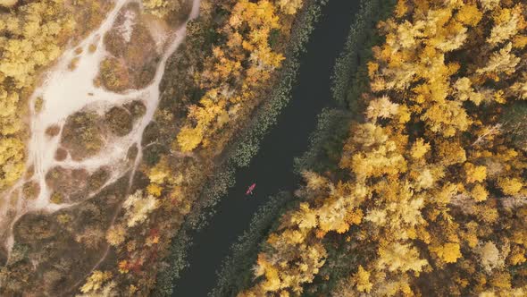 Horizontal aerial view on red kayak on Dnieper river in autumn day