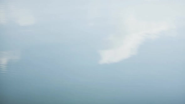 Reflection of clouds on rippled water alt