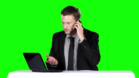 Businessman Sitting and Talking on the Phone. Green Screen alt