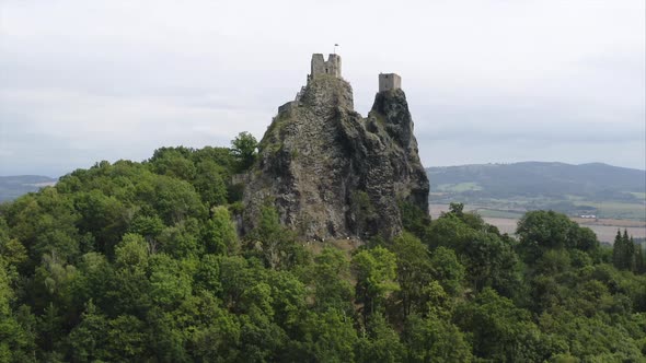 Ruins of the Trosky castle on a rocky outcrop amongst trees,Czechia. alt