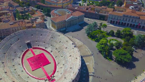 Aerial panoramic view of Arena di Verona, Italy. The drone flies in circle over the Arena and houses alt