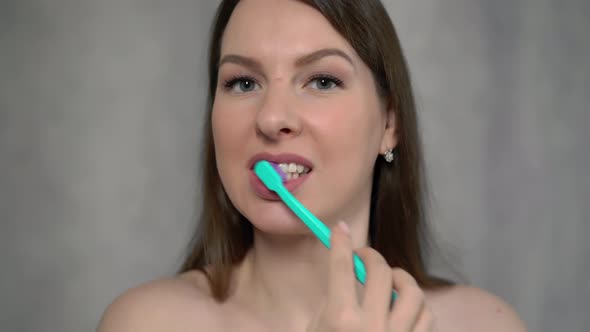 Woman Naked Cleans Her Teeth with Toothbrush and Paste After Shower