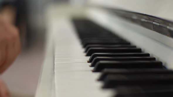 Extreme Closeup Hand of Unrecognizable Female Pianist Pushing One Piano Key on Classical Piano alt