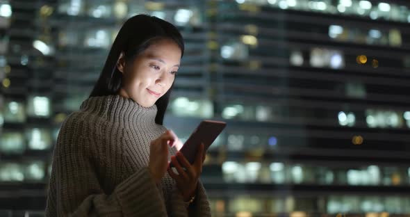 Young Woman Using Mobile Phone at Night alt