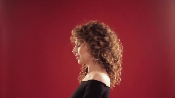 Woman with Curly Hair Dancing and Enjoying Music