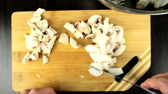 Cooking at Kitchen Slicing Mushrooms at Cutting Board