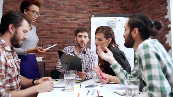Multiracial Team of Office Employees Brainstorming Sitting at Table Conference Meeting Room