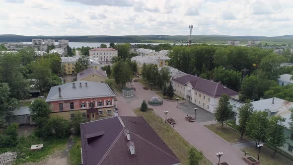 People walks along a beautiful alley in a provincial city. Poplar fluff flies 05 alt