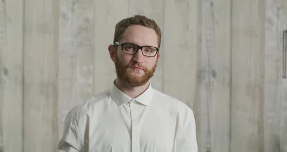 Attractive Young Bearded Man Shows Colorful Medical Masks to the Camera