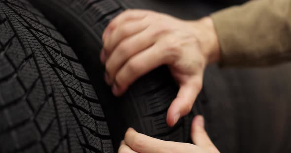 Man Customer Choosing New Tires Supermarket