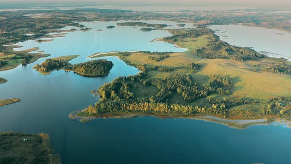 Aerial View Of Nedrava Lake And Green Forest Landscape In Sunny Summer Morning alt
