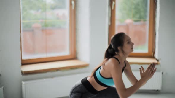 Young Fit Brunette Girl in Sportswear Does Exercises alt