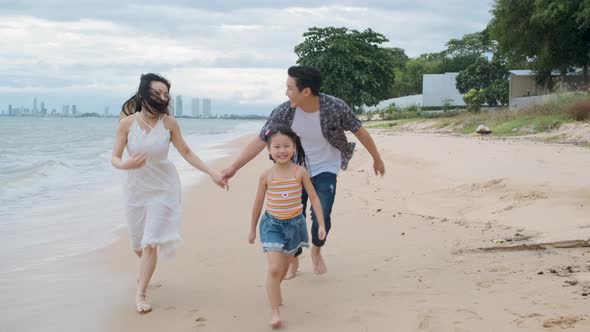 Asian Family walking at beach with kids happy vacation concept