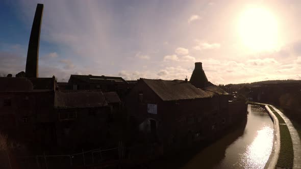 Aerial footage of an old abandoned, derelict pottery factory and bottle kiln located in Longport, St alt