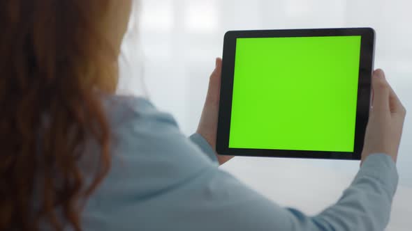 Close Up of Unrecognizable Girl Watching Videos Online on Digital Tablet with Green Chroma Key alt