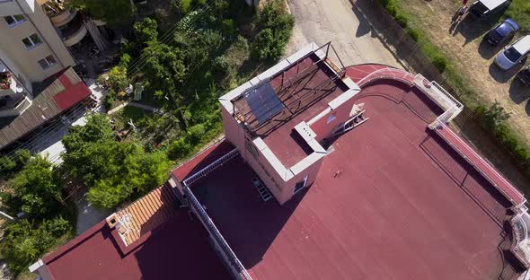 Drone Circling View of the Red Roof with Solar Panels