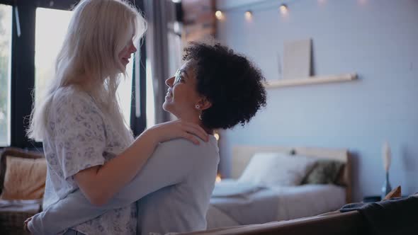 Lesbian Young Couple Dance and Smile Kissing and Talking Sitting on the Couch alt