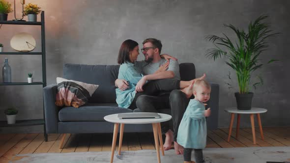 Young Family Playing Together on the Sofa alt
