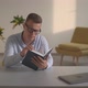 a Man in the Office Reading a Book - VideoHive Item for Sale
