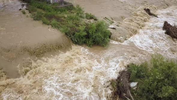 Aerial View of Wide Dirty River with Muddy Water in Flooding Period During Heavy Rains in Spring alt