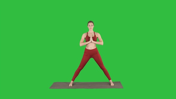 Young woman practicing yoga finishes doing Utthita parsvakonasana alt