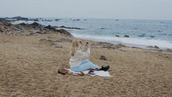 Woman Takes Photo of Seascape