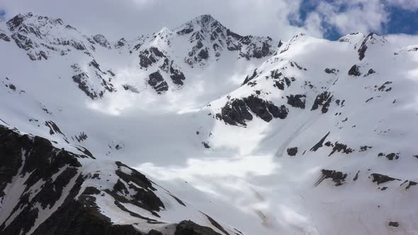 Flight above snowcapped mountains near Elbrus