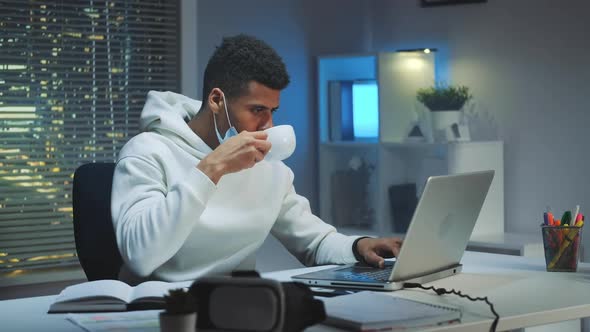 Multiracial Man on Quarantine Working Home Late at Night alt