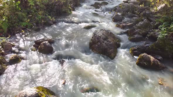 Closeup of a Mountain River Flight of an Unmanned Camera Directly Over the Water of a Mountain River alt