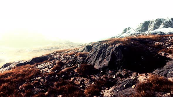 Beautiful Scenic Sunset View at Mountain Range and Dry Yellow Grass in Front alt