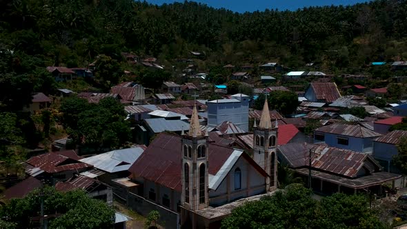 Aerial drone view of a small isolated village and situated at the bottom of a mountain close to the alt