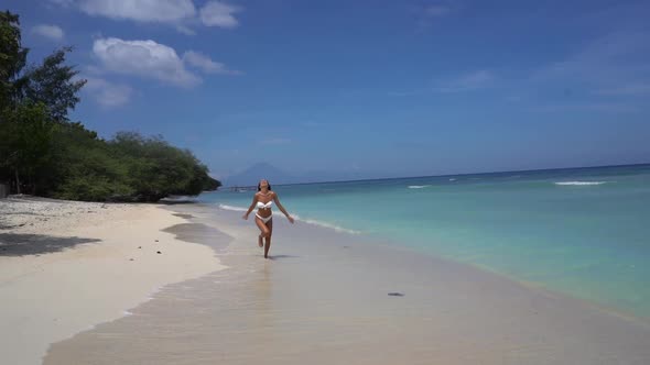 Happy Pretty Girl Running in Bikini Through Sandy Coastline Joyful Carefree Exotic Vacation alt