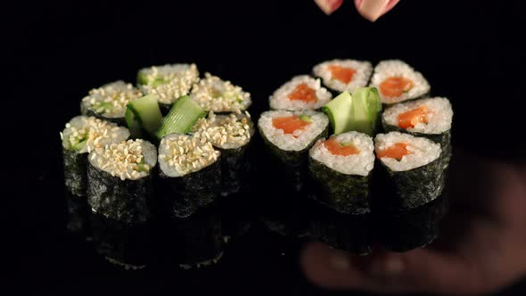 The Chef Decorates Cucumber Sushi Before Serving alt